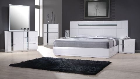 Modern bedroom furniture set with a bed, side tables, and wardrobe.