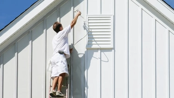 house-painter-on-ladder-painting-exterior